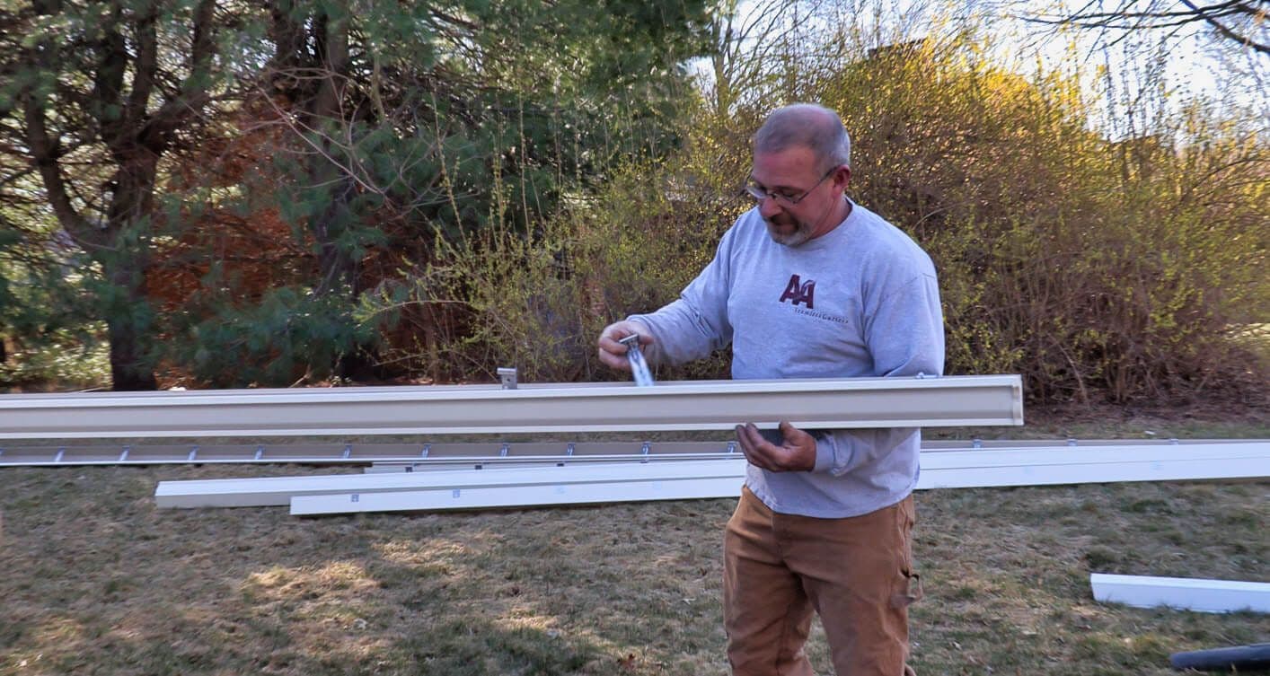 A&A Seamless Gutters team member preparing custom gutter sections